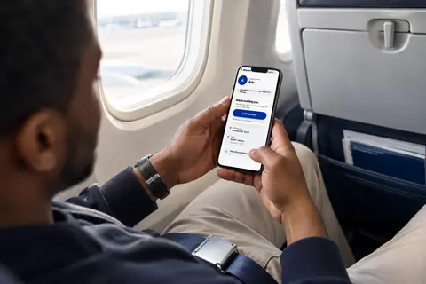 A passenger tapping I've landed on her phone